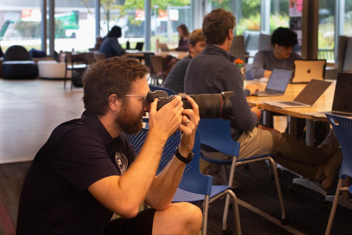 Ben Heider photographing working students