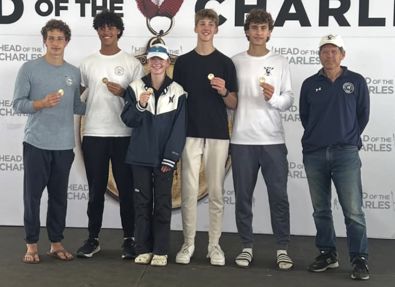 Left to right: Leo Davidson (Class II), Elliot Davis (Class II), Grace Curran (Class II), James Bourell (Class III), Henry Hazen (Class III), and Boys Crew Coach Adam Balogh holding bronze medals at HOCR