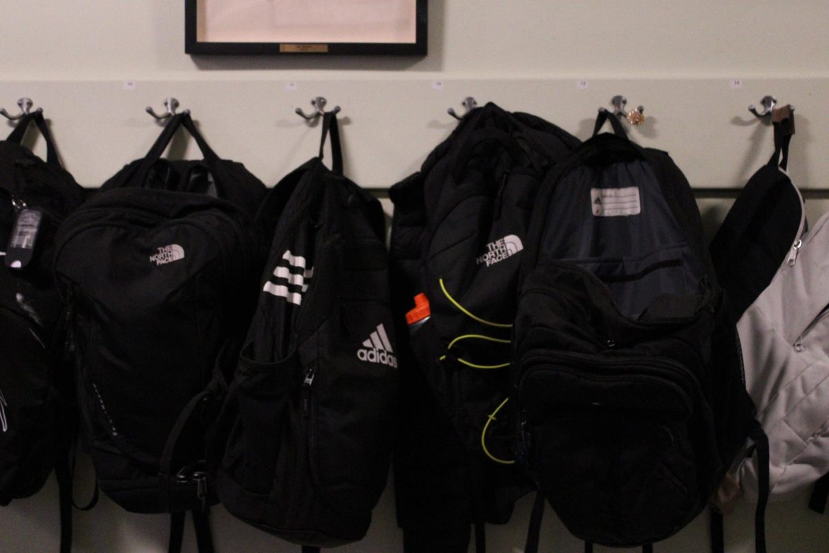 All-black backpacks in middle school hallway