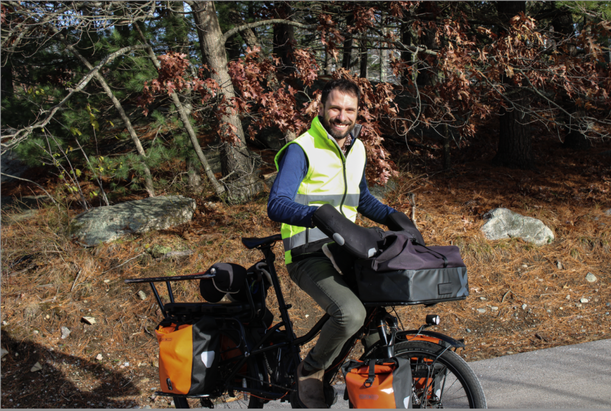 Mathematics Faculty Dan Reid biking on campus