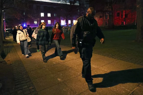 Brown University students are escorted by police as they leave a building on Saturday