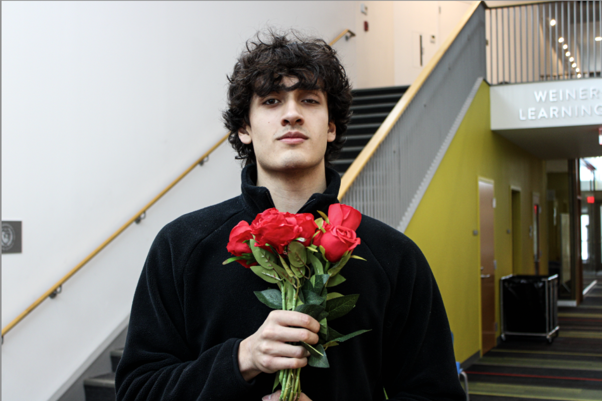 Ricardo Watkins (Class I) posing with his roses from the CAC Rose Sale