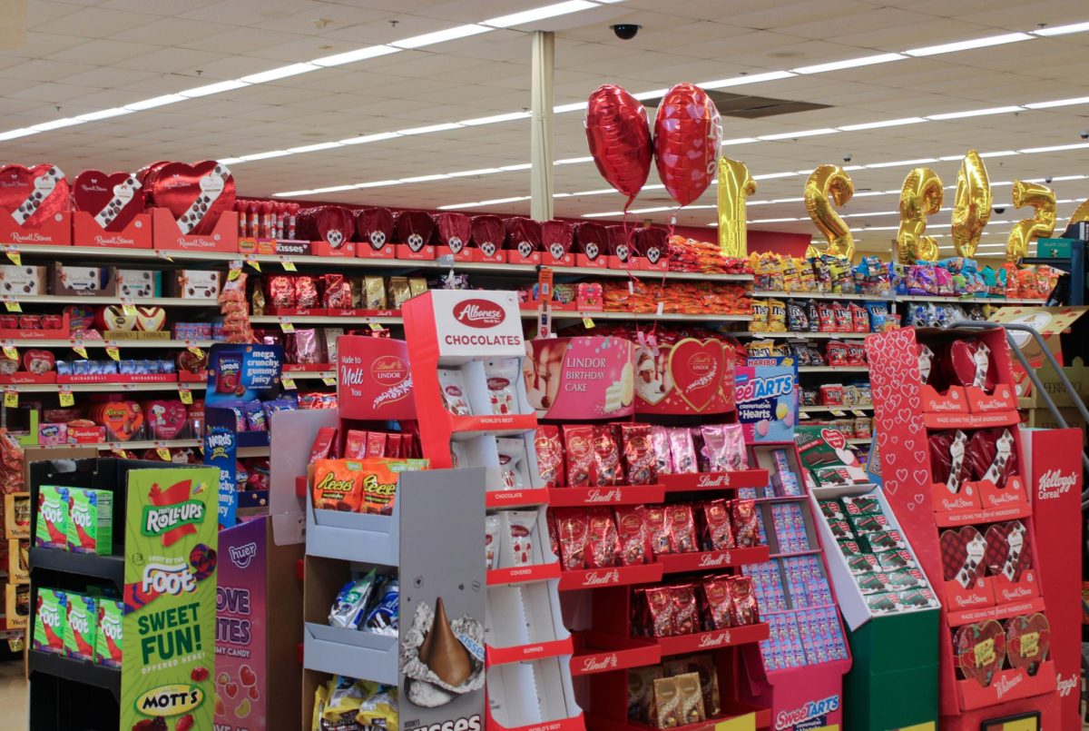 A store aisle filled with chocolate and other Valentine’s Day themed candy