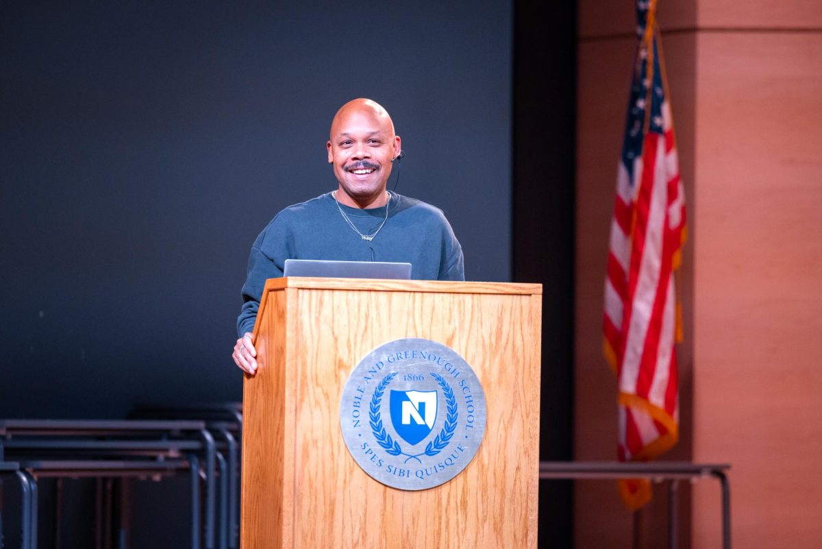 Tre Johnson speaking in long assembly about Black Genius